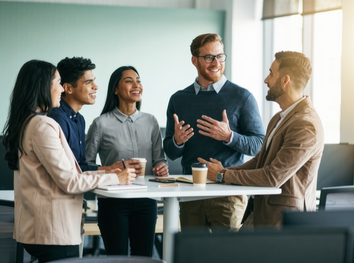 Growing team in a quick stand-up meeting (illustrative image)