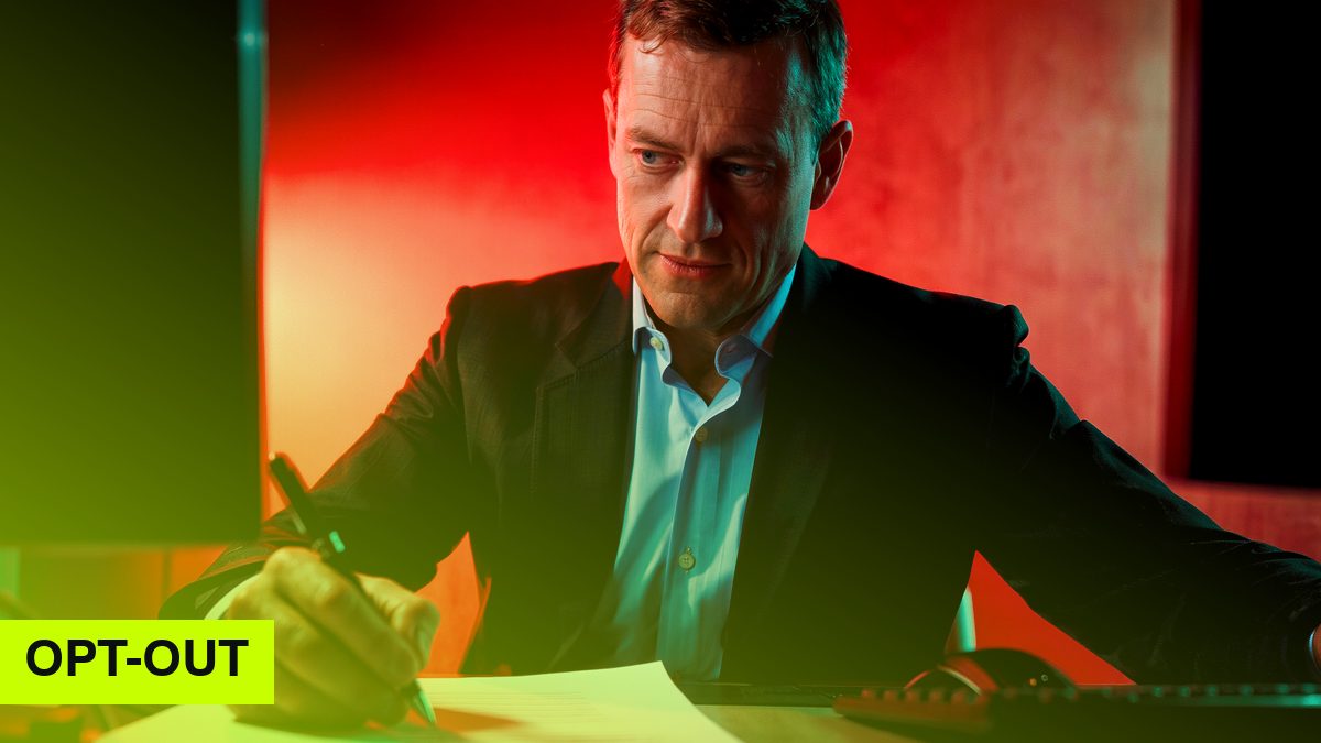 Erfundener Büroangestellter schreibt nachdenklich mit dem Stift auf Papier, rotes und türkisfarbenes Licht (KI-Bild)